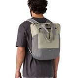 Patagonia Terravia tote bag in river rock green worn by a adult on the back showing the carrying handle details and side pockets for holding bottles