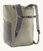 Back view of the Patagonia Terravia tote bag in river rock green colour showing the grey strap detail with buckle for fastening. Features side pockets for holding bottles.