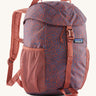 The Patagonia Kids Refugito 12L Backpack   , a dark coral colour backpack with blue patterns all over. Features 2 side mesh pockets and a buckle to close the lid. Logo patch is stitched on the front panel.