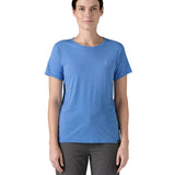 Patagonia women's short sleeve top in light blue beach outline and logo design worn by a woman