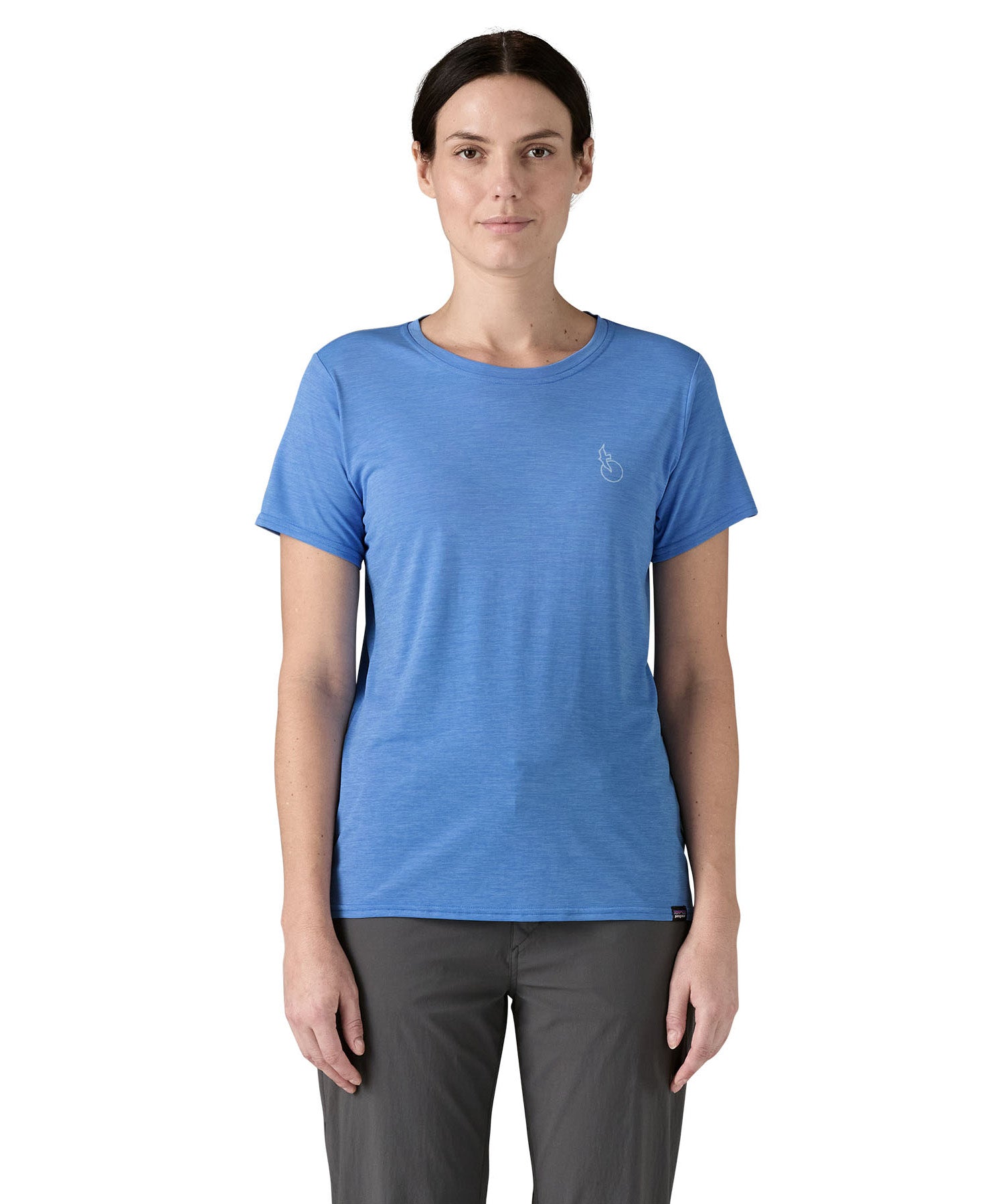 Patagonia women's short sleeve top in light blue beach outline and logo design worn by a woman