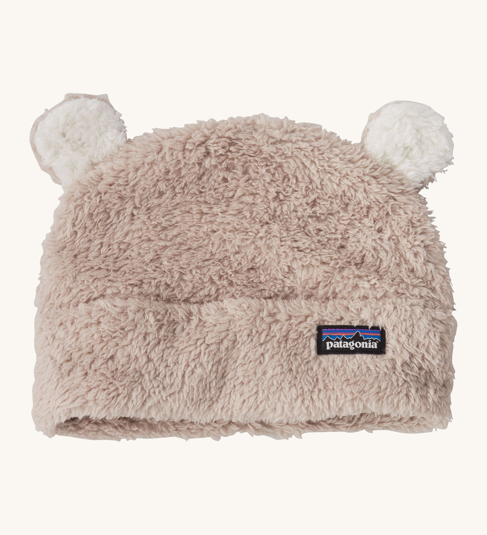 Patagonia little kids friends hat. A light grey furry beanie to keep the head warm which features white bear-like ears on the top of the beanie. Features the logo patch stitched on the front side of the hat.