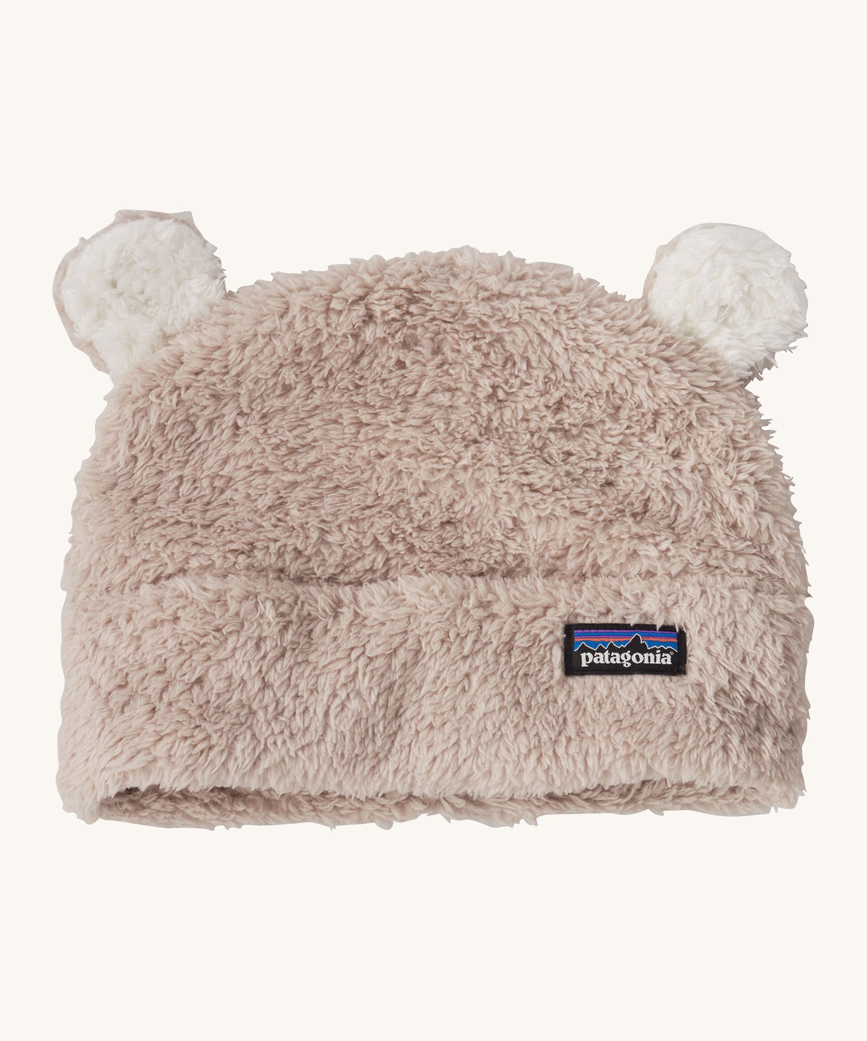 Patagonia little kids friends hat. A light grey furry beanie to keep the head warm which features white bear-like ears on the top of the beanie. Features the logo patch stitched on the front side of the hat.