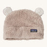 Patagonia little kids friends hat. A light grey furry beanie to keep the head warm which features white bear-like ears on the top of the beanie. Features the logo patch stitched on the front side of the hat.