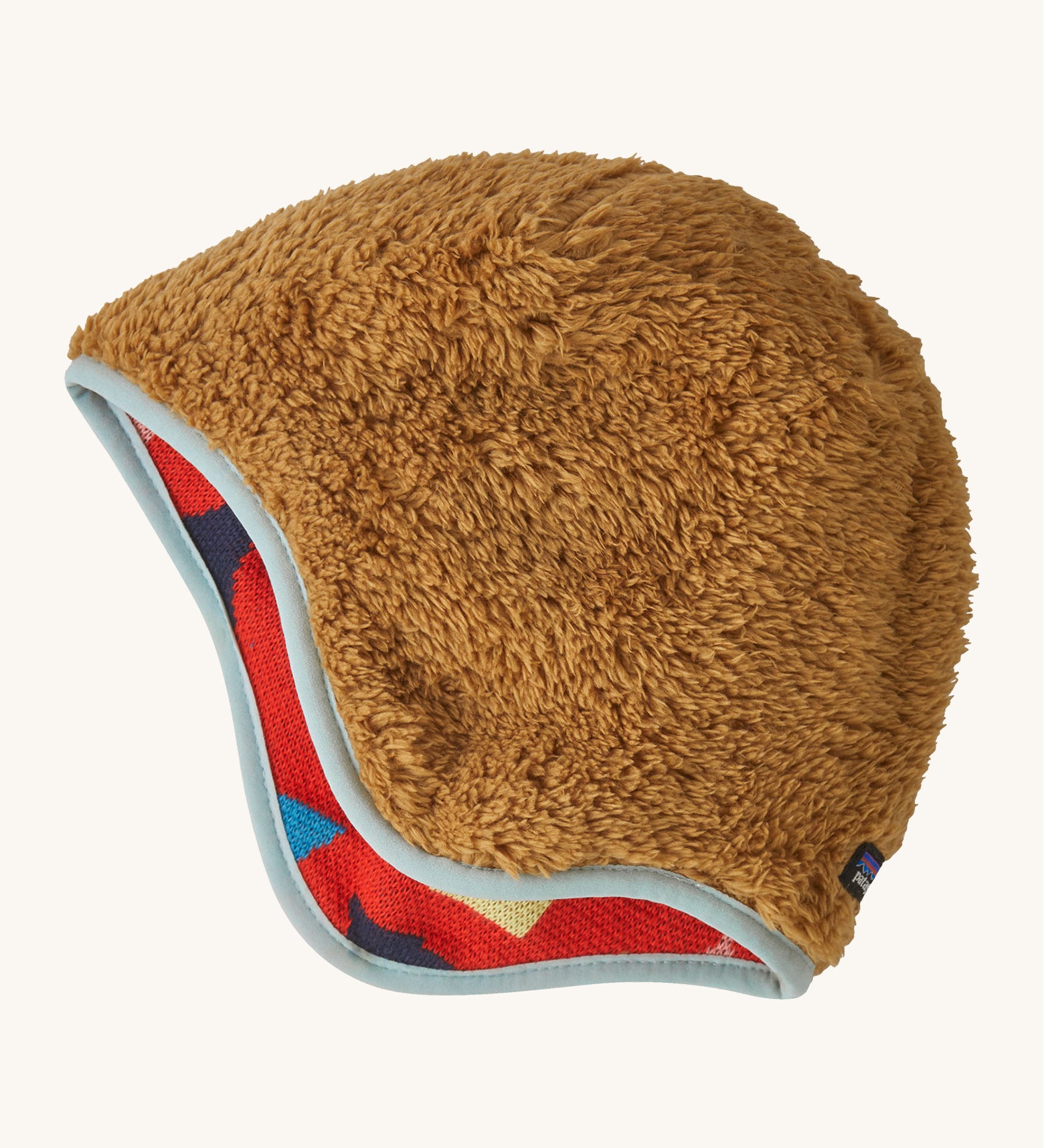 The reversible side of the Patagonia beanie showing the brown cosy fleece fur and light blue trim. Features the logo patch stitched on the back.