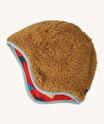 The reversible side of the Patagonia beanie showing the brown cosy fleece fur and light blue trim. Features the logo patch stitched on the back.