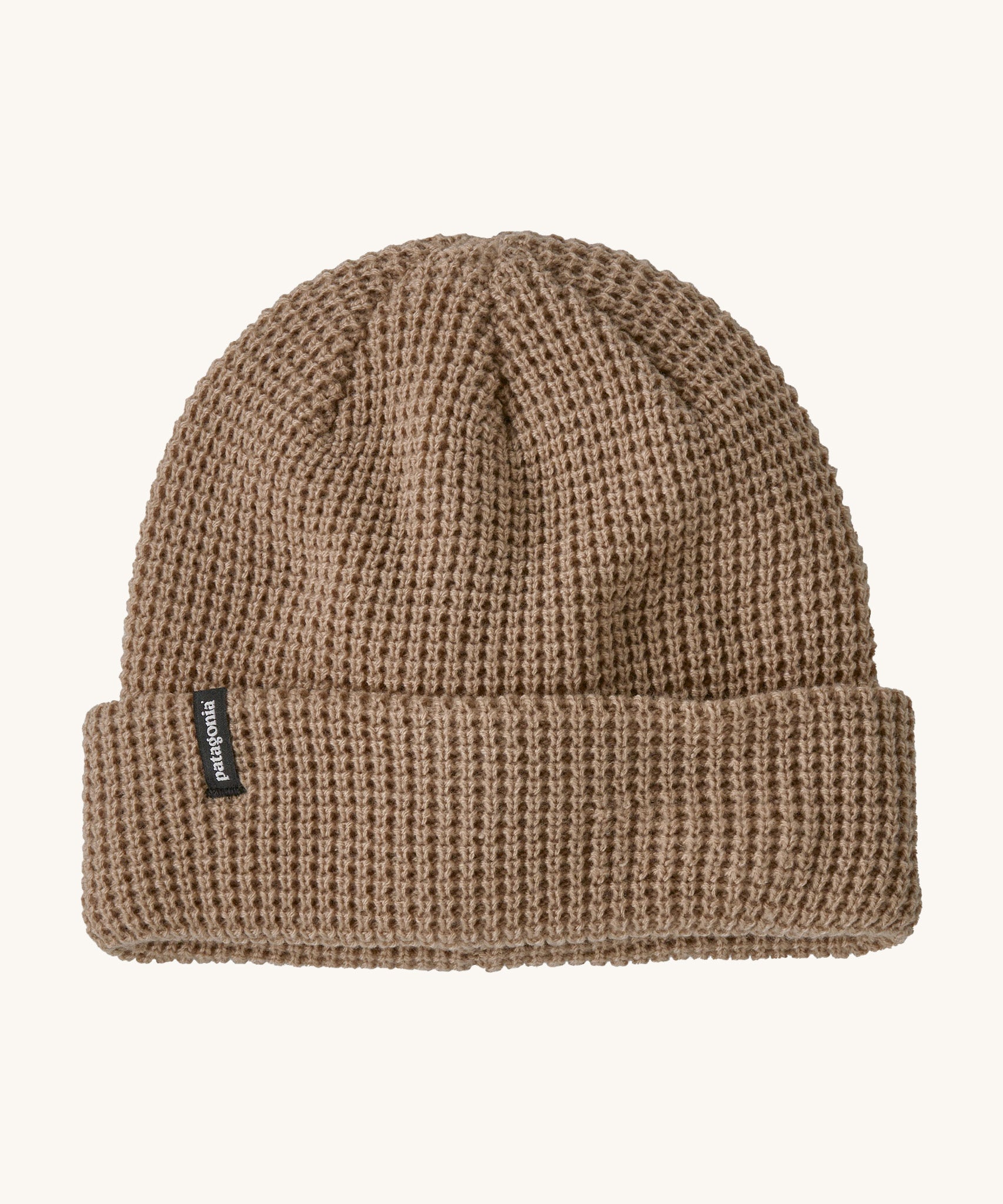 Patagonia adult snow drifter beanie in a pale khaki colour. A ribbed knitted style beanie with the logo branding on the side of the turn up brim.