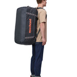 Patagonia 100 litres duffel bag in a navy blue colour carried by an adult