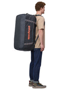 Patagonia 100 litres duffel bag in a navy blue colour carried by an adult