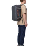 Patagonia 40 litres duffel bag in a dark navy blue colour carried by an adult bottom detail