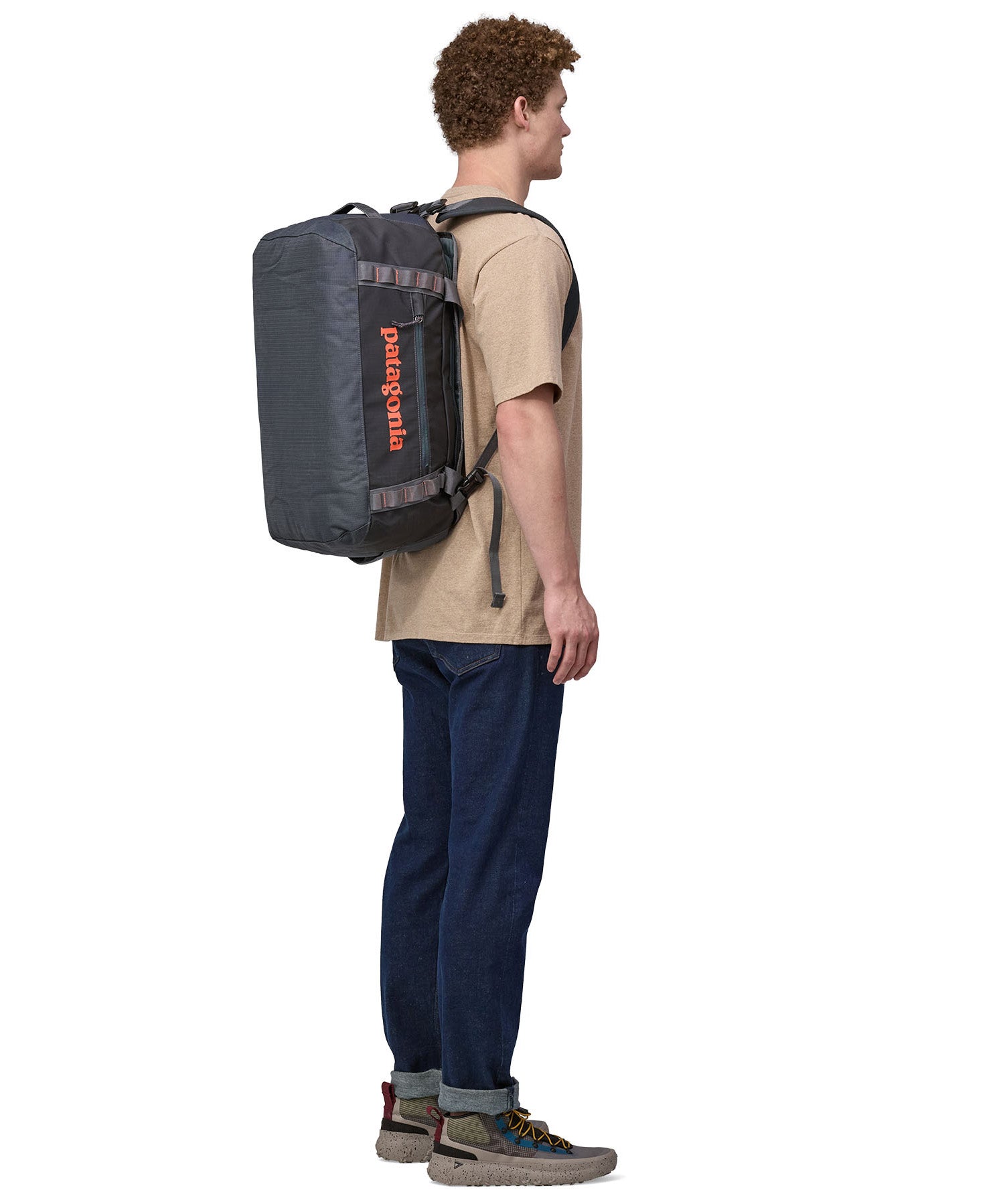 Patagonia 40 litres duffel bag in a dark navy blue colour carried by an adult bottom detail