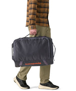Patagonia 40L black hole wheeled duffel bag being carried by an adult