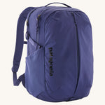 Patagonia purple 26L day refugio backpack on a cream background.