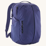 Patagonia purple 26L day refugio backpack on a cream background.