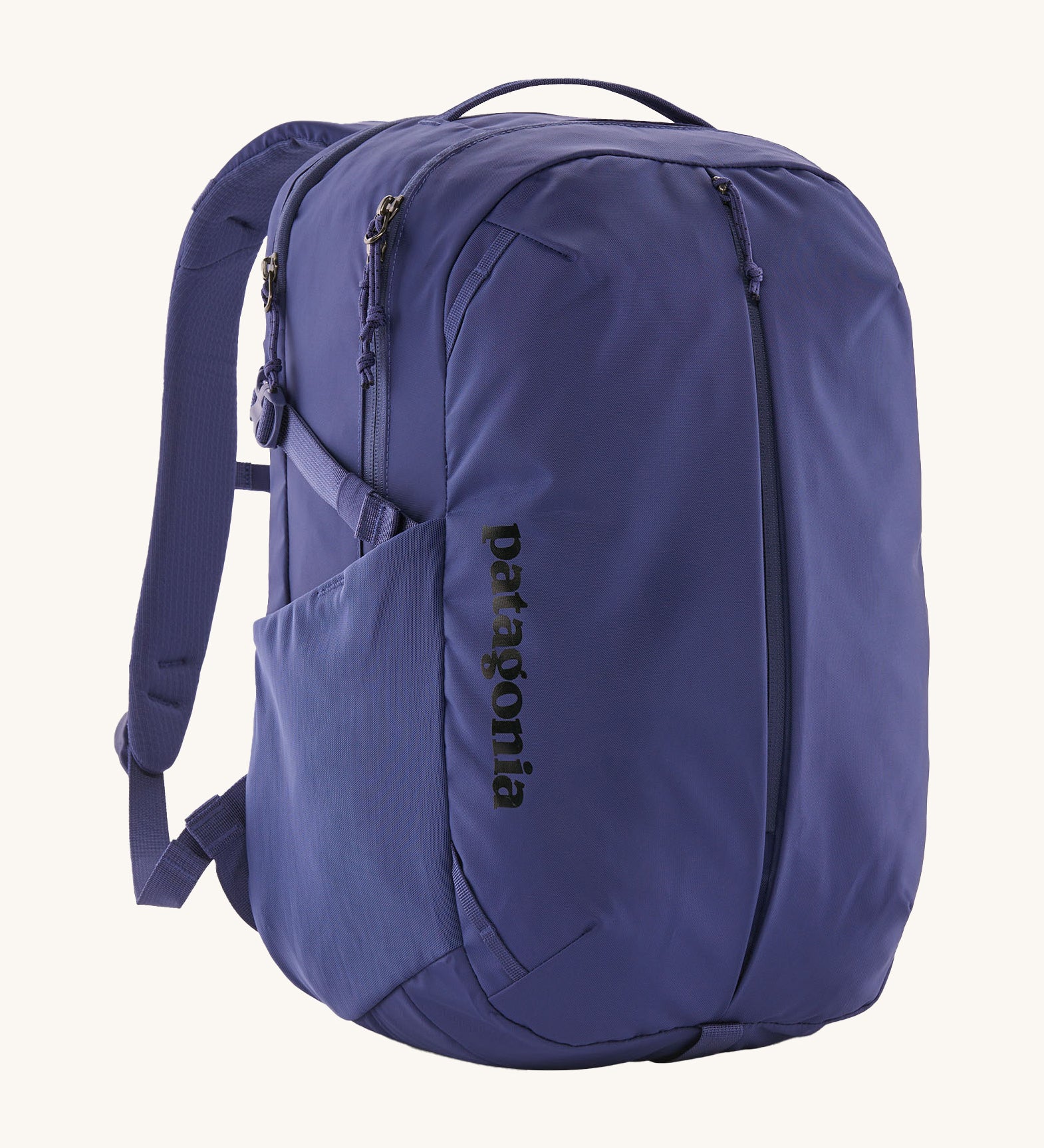 Patagonia purple 26L day refugio backpack on a cream background.