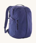 Patagonia purple 26L day refugio backpack on a cream background.