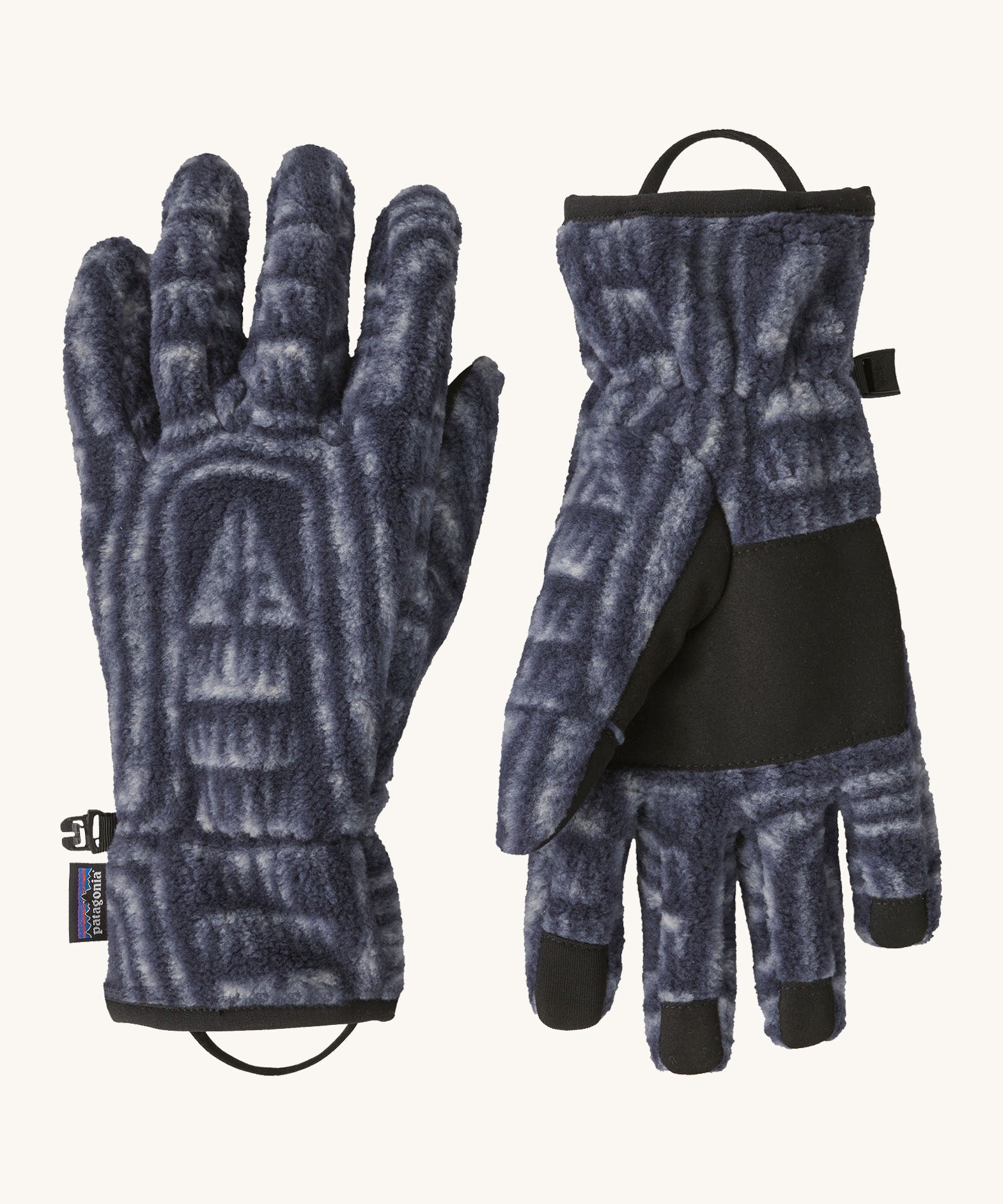 Patagonia adult synchilla gloves in sunken blue. Dark blue gloves with retro patterns, features a grip on the palms and fingertips. Logo label is stitched on the side . 