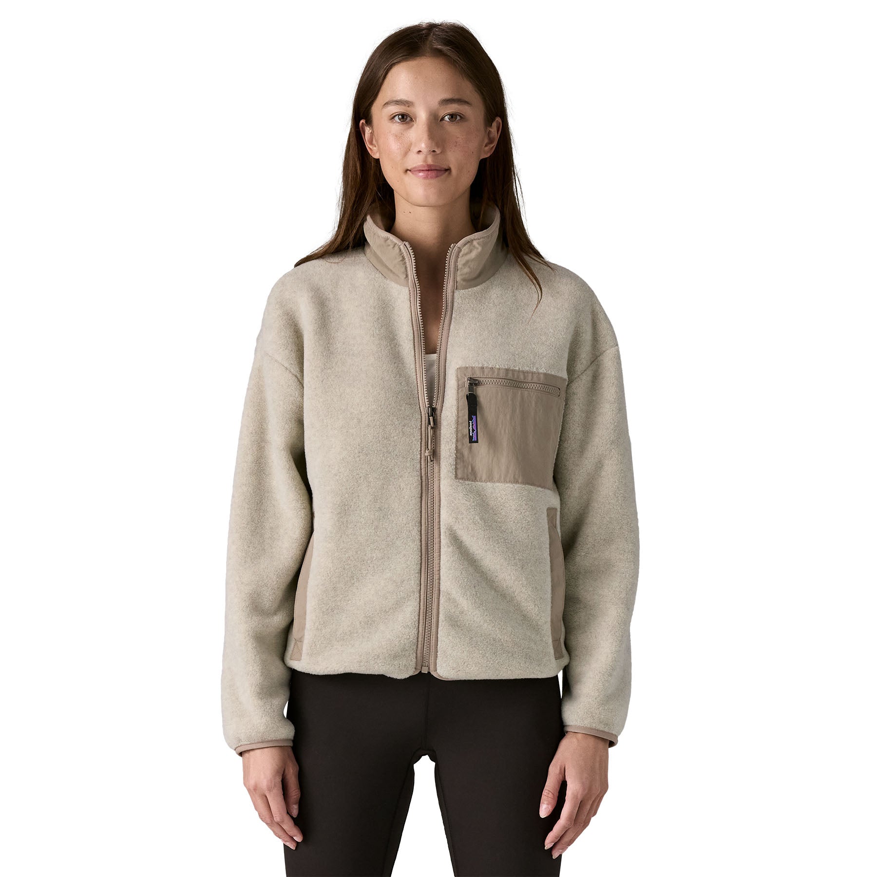 A woman Patagonia Women's Synchilla® Fleece Jacket in Oatmeal Heather / Seabird Grey is a pale oatmeal full zip fleece jacket available at Babipur