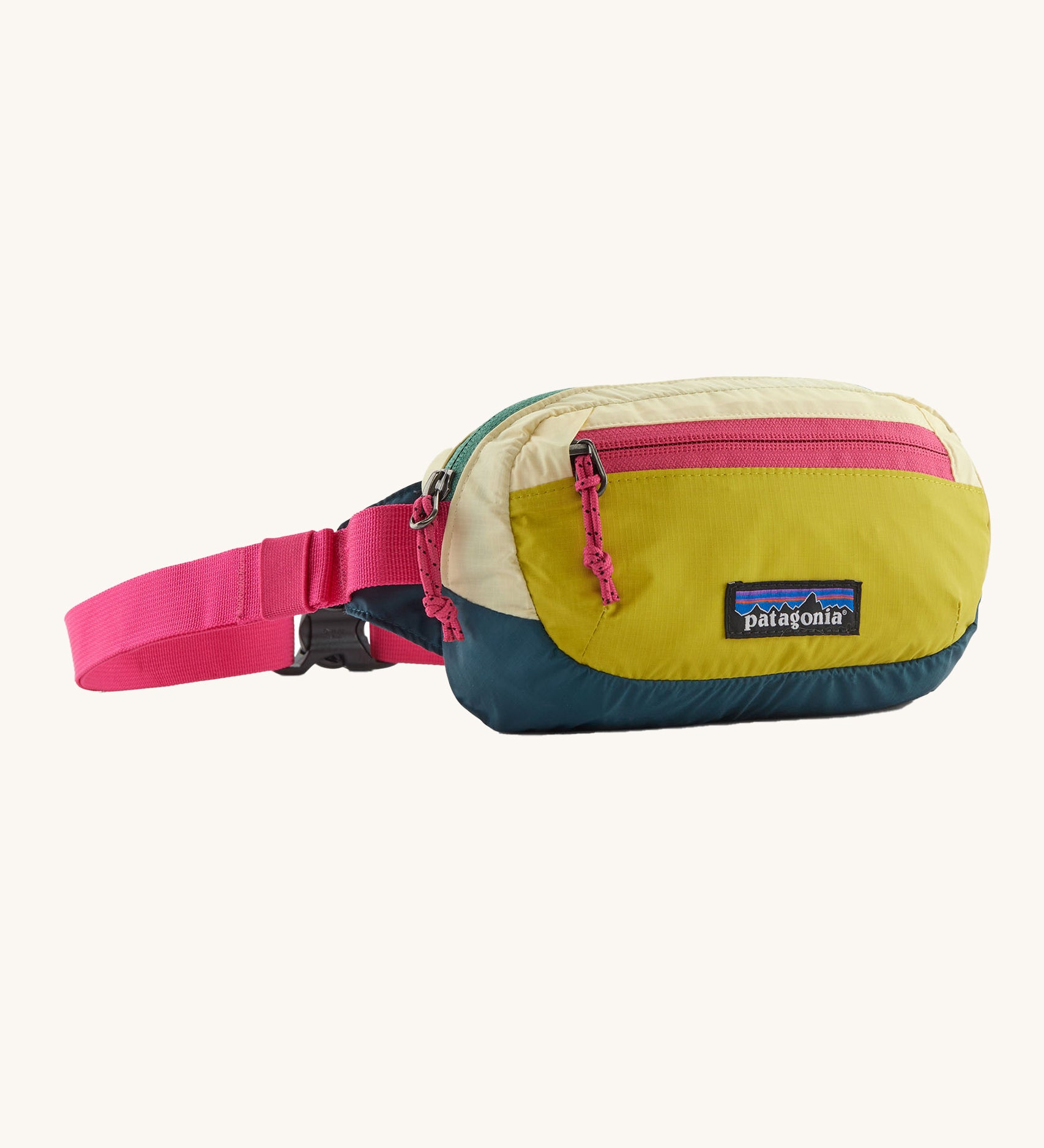 The Patagonia Terravia Mini Bum Bag, with yellow shades on the main pack and neon pink zippers and straps.