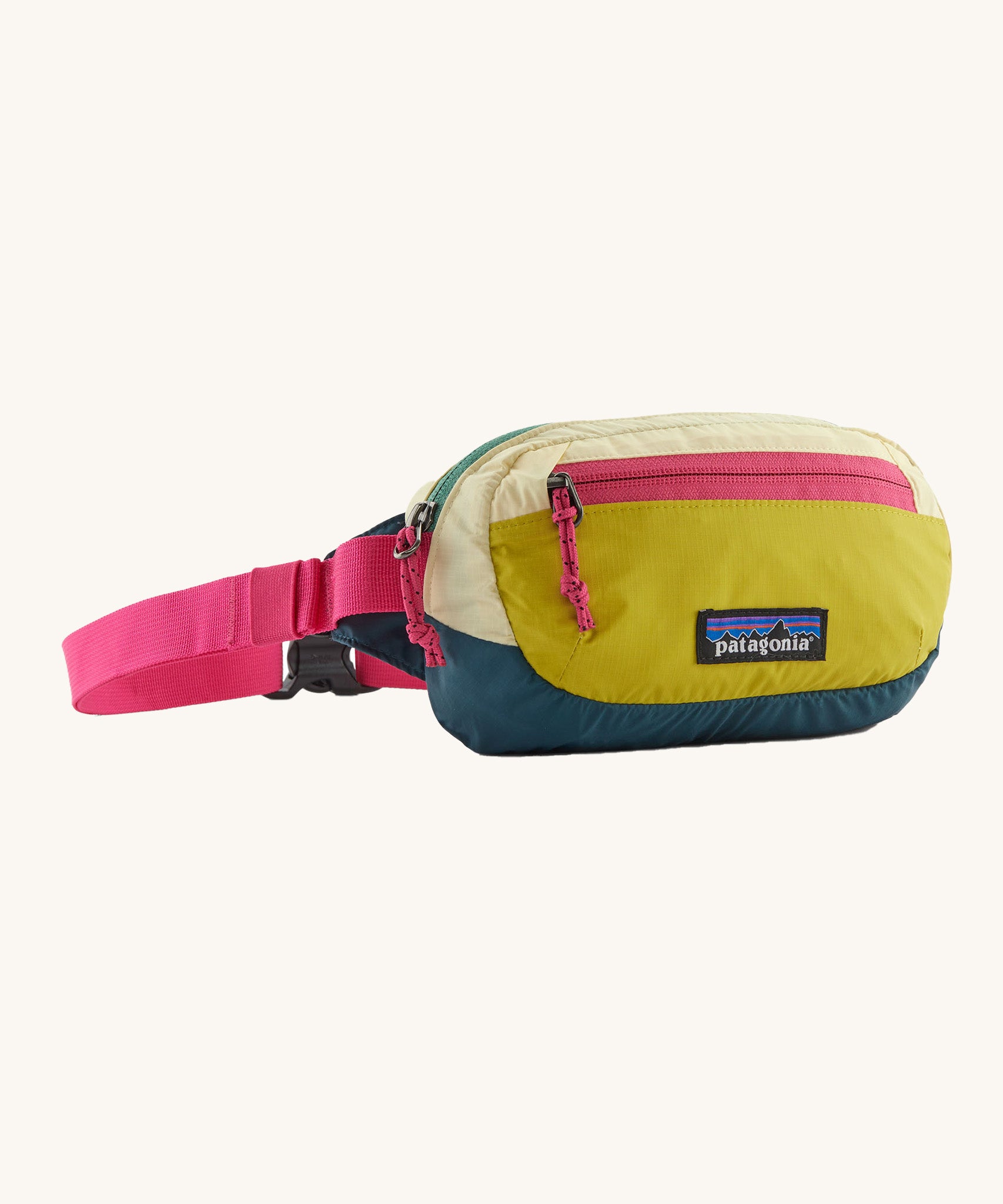 The Patagonia Terravia Mini Bum Bag, with yellow shades on the main pack and neon pink zippers and straps.