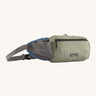 Patagonia terravia hip bag in a river rock green colour on a cream background.