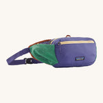 Patagonia terravia hip bag in a solstice purple colour on a cream background.