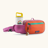 Patagonia terravia hip pack in bright purple with an orange front panel showing bottle inside the mesh pocket and pocket hanging from loop