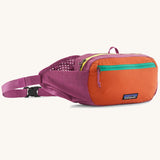 Patagonia terravia hip pack in bright purple with an orange front panel and quick release buckle closure and mesh side pockets