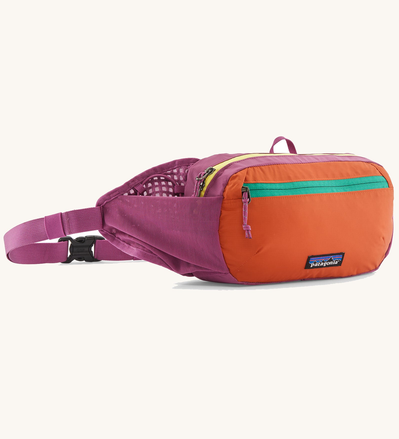 Patagonia terravia hip pack in bright purple with an orange front panel and quick release buckle closure and mesh side pockets