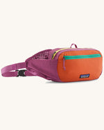 Patagonia terravia hip pack in bright purple with an orange front panel and quick release buckle closure and mesh side pockets