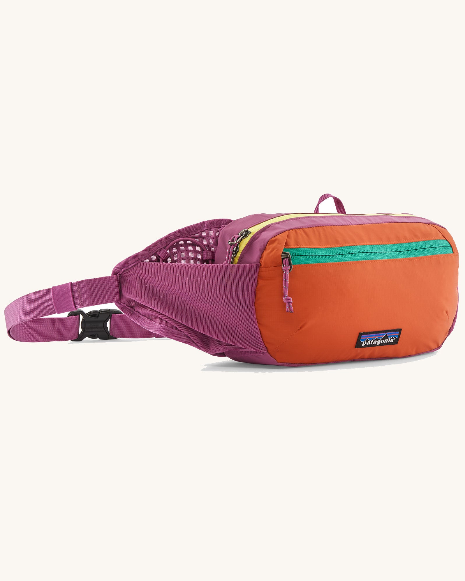 Patagonia terravia hip pack in bright purple with an orange front panel and quick release buckle closure and mesh side pockets