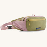 Patagonia terravia hip pack in quiet violet with a green front panel and a small black logo tag on the front. 