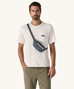 A man wearing the Patagonia Terravia Mini Bum Bag Hip Pack in a Smolder Blue colour on his shoulder across his chest. 