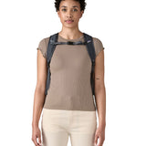 Patagonia Terravia tote bag in smolder blue worn by a adult on the shoulder showing the buckle fastening 
