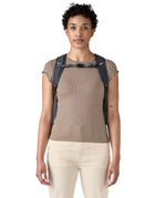 Patagonia Terravia tote bag in smolder blue worn by a adult on the shoulder showing the buckle fastening 