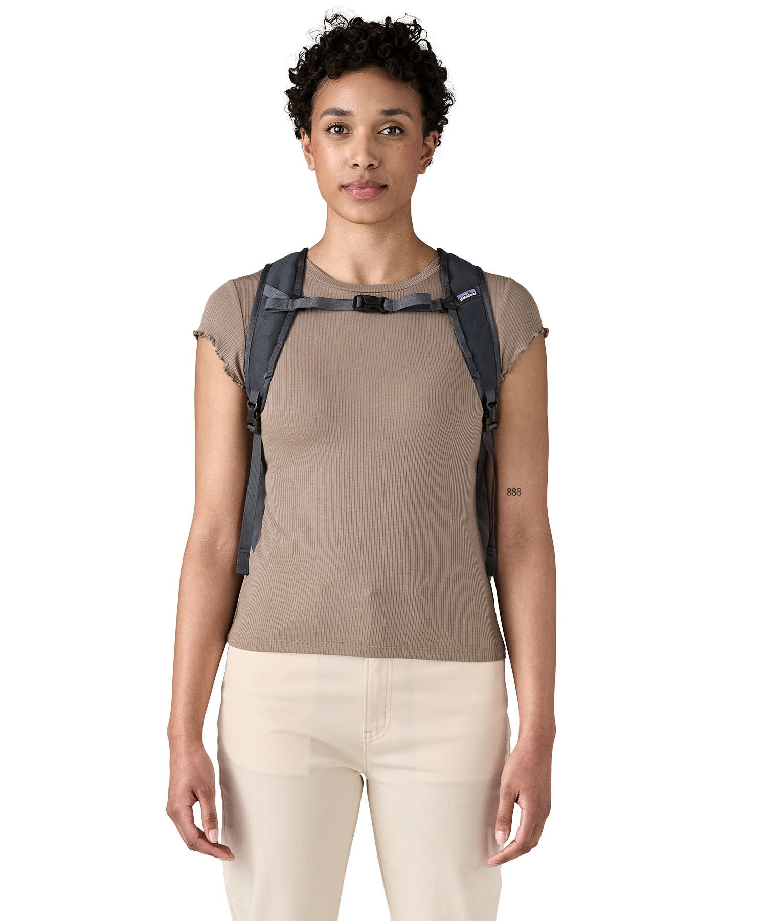 Patagonia Terravia tote bag in smolder blue worn by a adult on the shoulder showing the buckle fastening 