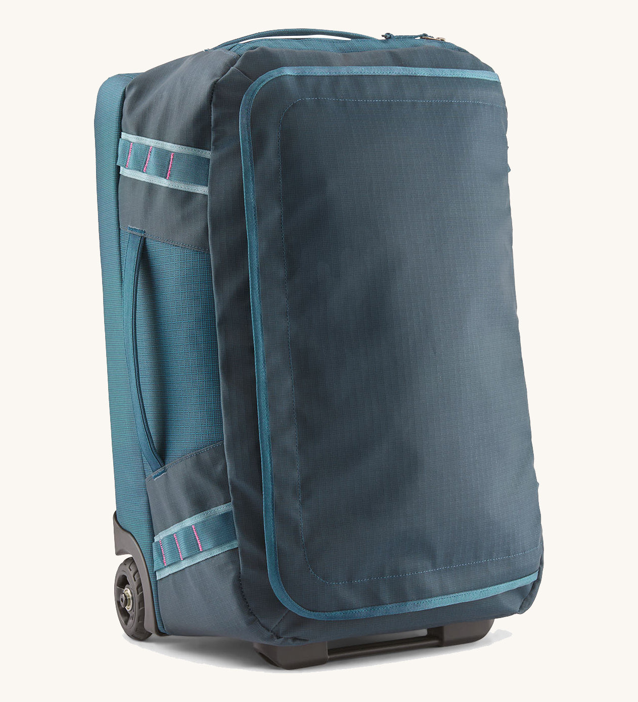 Patagonia 40L wheeled duffel bag in a tidal teal colour on a cream backgroud.