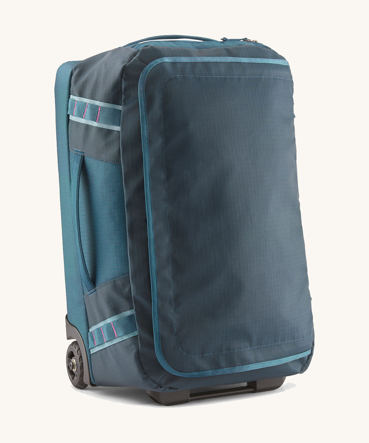 Patagonia 40L wheeled duffel bag in a tidal teal colour on a cream backgroud.