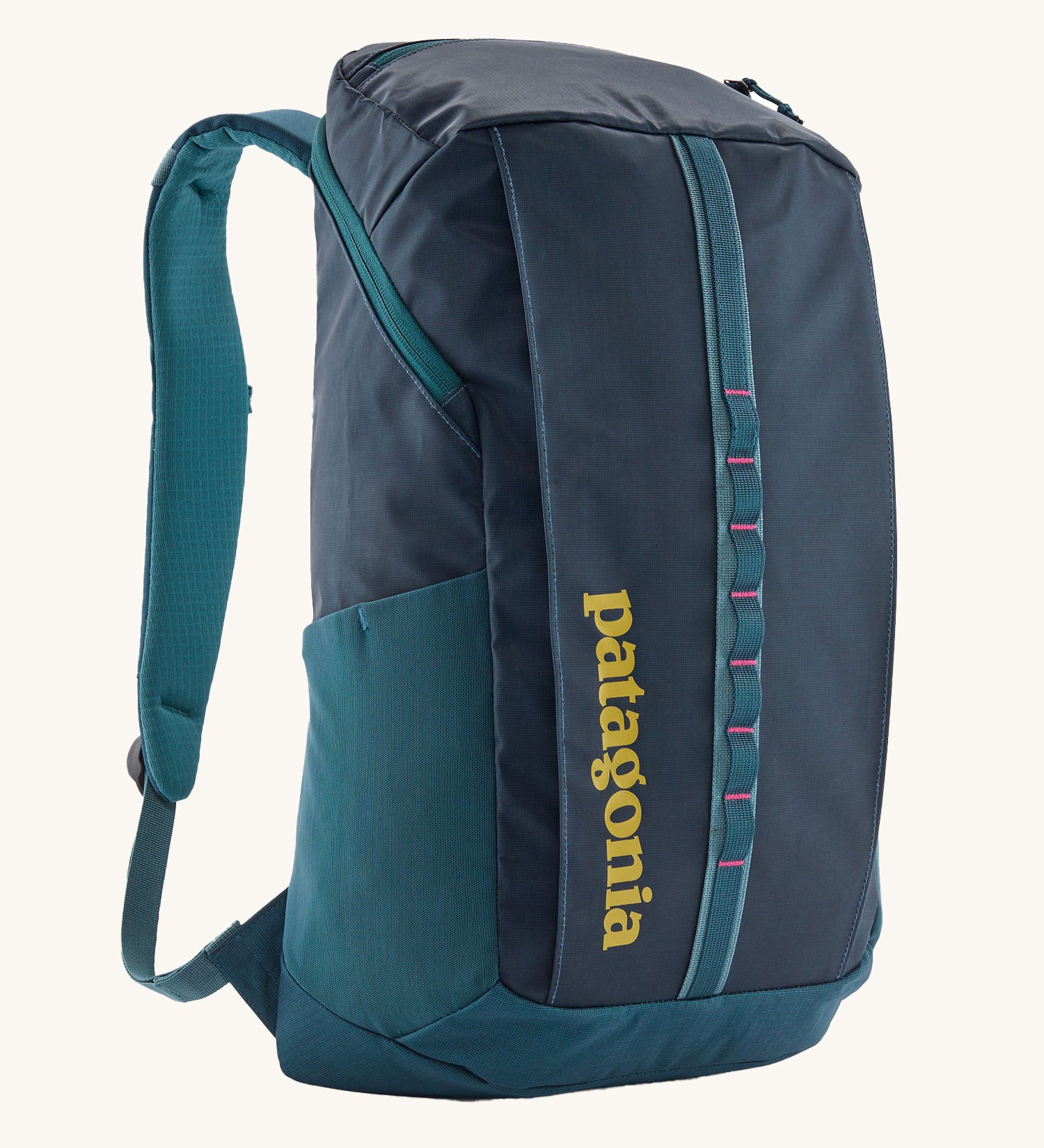 Patagonia 25L black hole backpack in a tidal teal colour on a cream background.