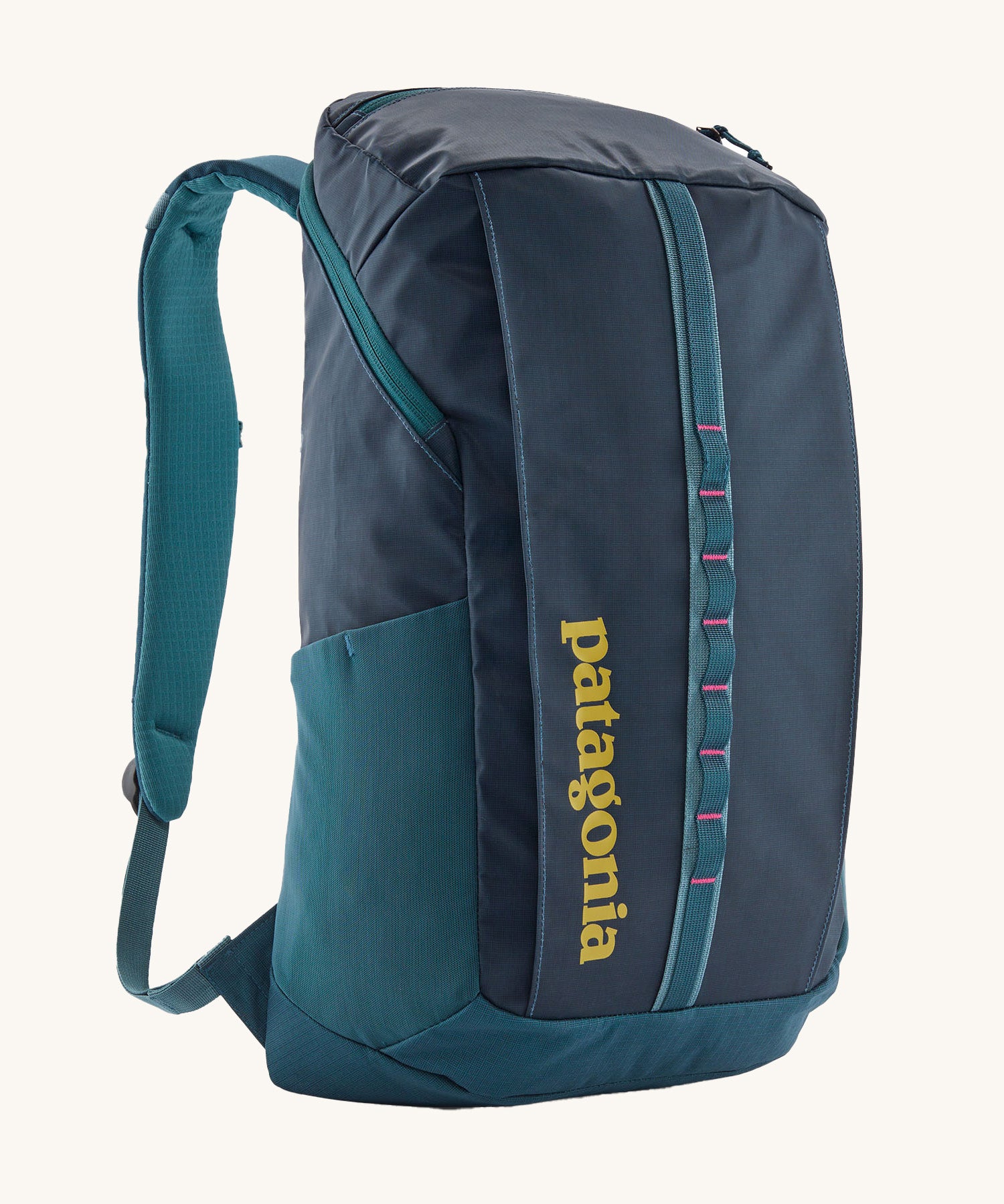 Patagonia 25L black hole backpack in a tidal teal colour on a cream background.