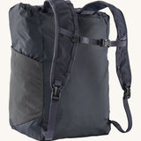 Back view of the Patagonia Terravia tote bag in smolder blue colour showing the blue strap detail with buckle for fastening. Features side mesh pockets for holding bottles.