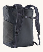 Back view of the Patagonia Terravia tote bag in smolder blue colour showing the blue strap detail with buckle for fastening. Features side mesh pockets for holding bottles.