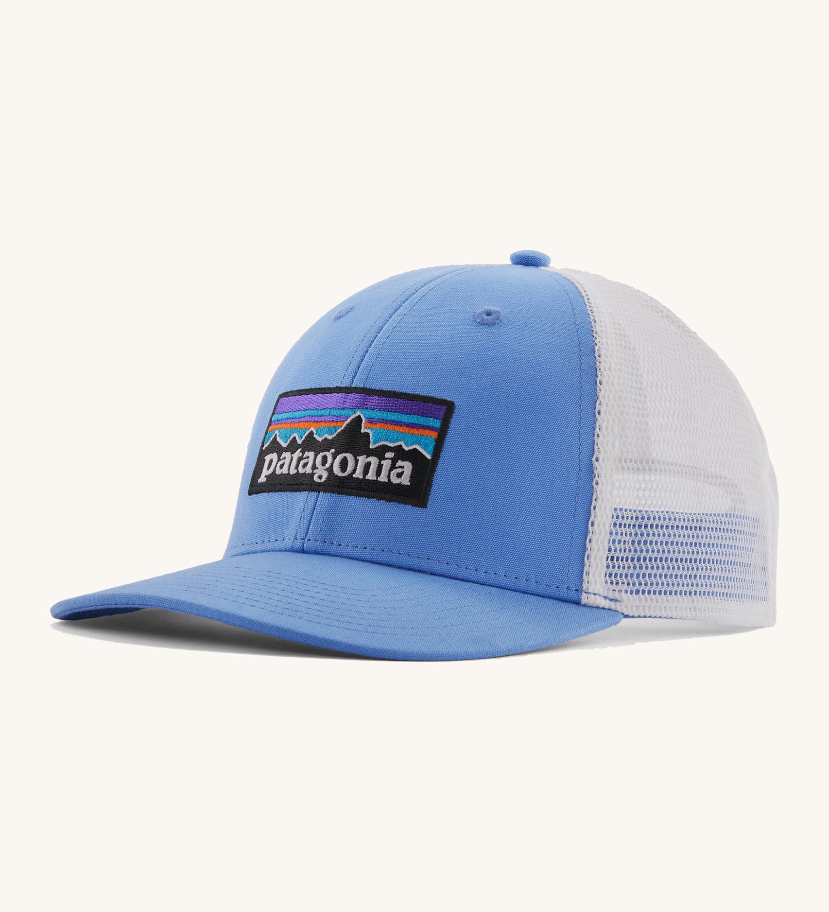Patagonia low trucker hat in a light blue colour on a cream background.