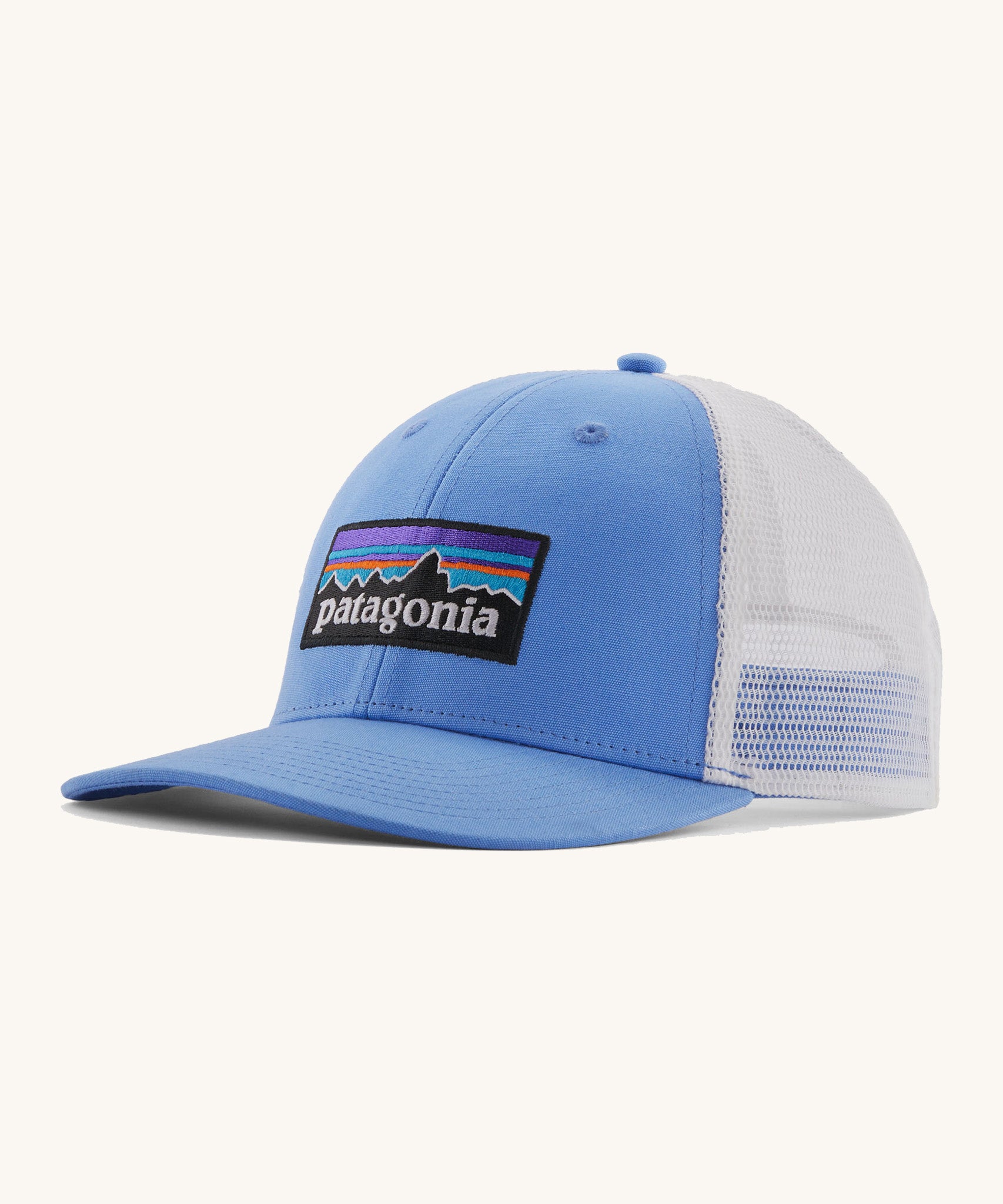 Patagonia low trucker hat in a light blue colour on a cream background.