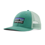 Patagonia low trucker hat in a light green colour on a cream background.