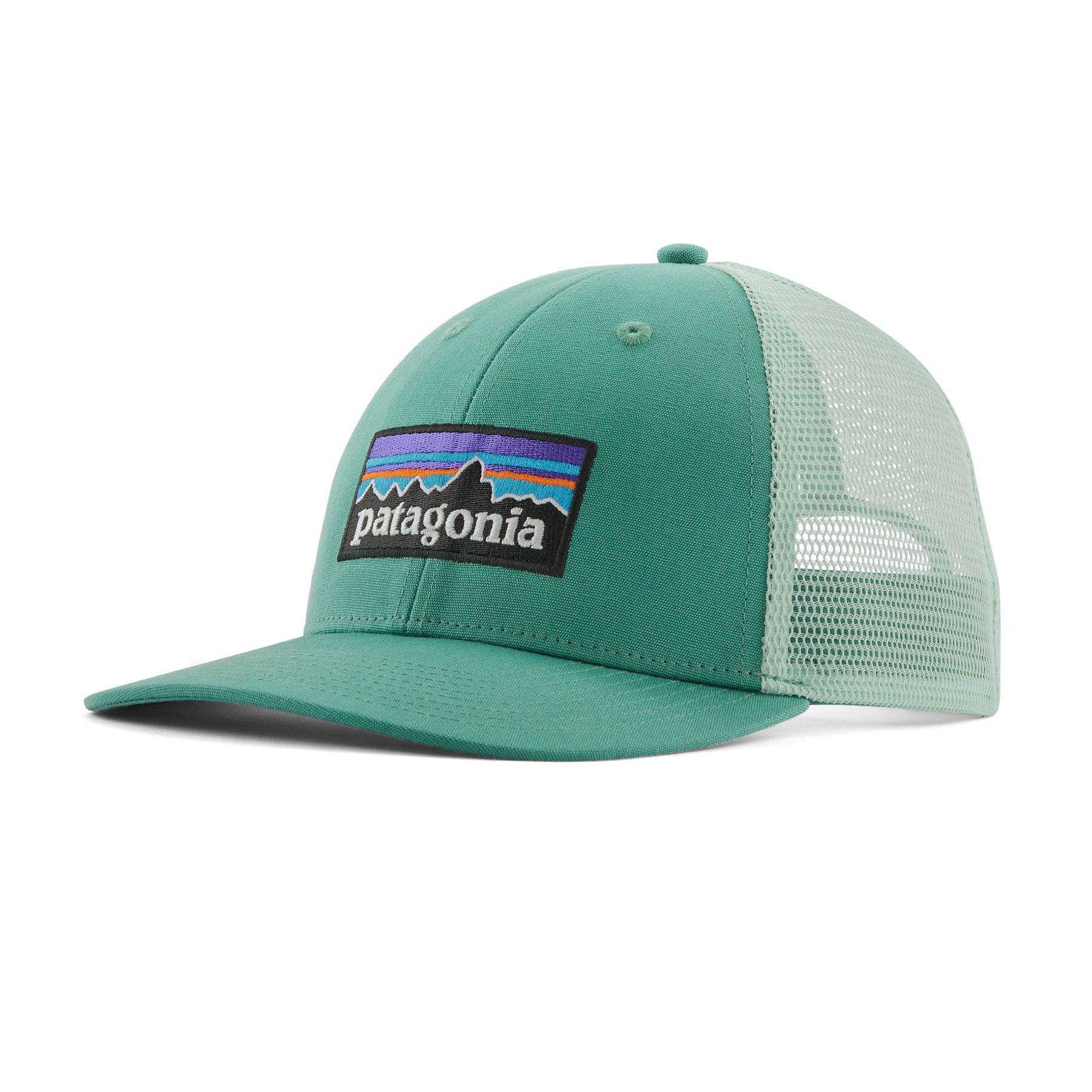 Patagonia low trucker hat in a light green colour on a cream background.