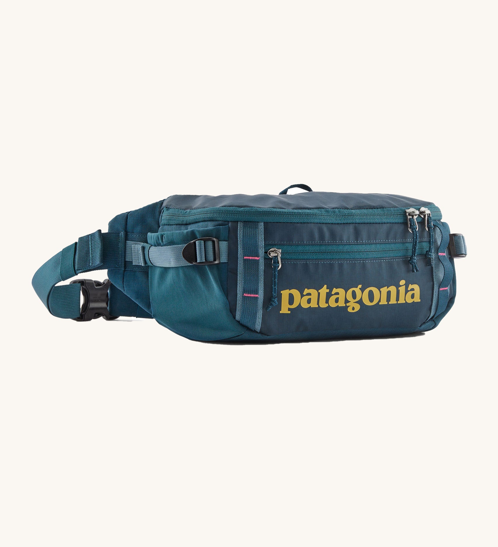 Patagonia 5L waist pack in a tidal teal colour on a cream background