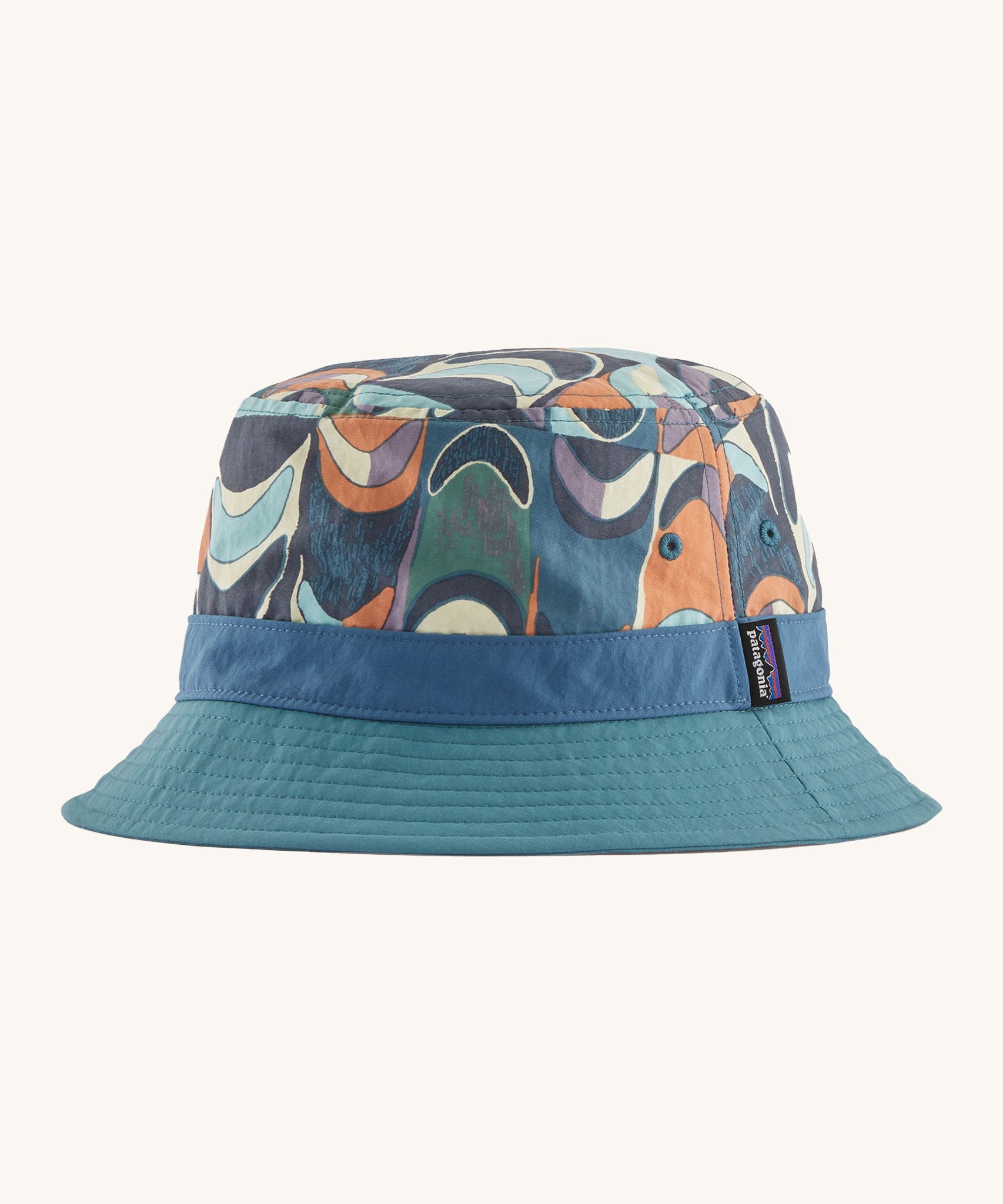 Patagonia wavefarer bucket hat in  blue and multicoloured geo design on a cream background.