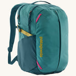 Patagonia turquoise 26L day refugio backpack on a cream background.
