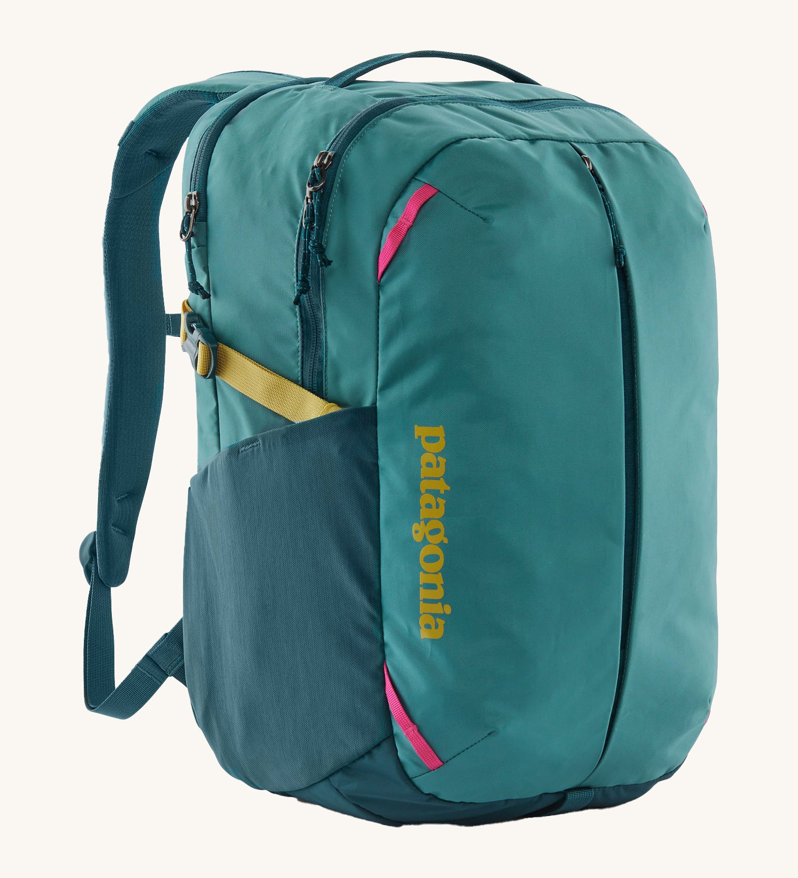 Patagonia turquoise 26L day refugio backpack on a cream background.